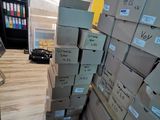 many boxes stacked on top of each other in a room