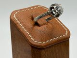 a ring in a wooden box on a white background