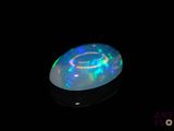 a white frisbee that is lit up in the dark