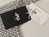a black and white picture of a necklace with a tag on it