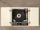 an overhead view of a record player in a white cabinet