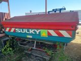 a red and blue truck parked in the grass