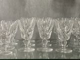 bottles and glasses on a glass shelf in a room
