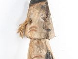a wooden statue of a man with a hat on his head