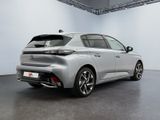 the rear end of a silver car in a white room