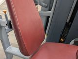 an image of a close up of a gym bench with a red seat