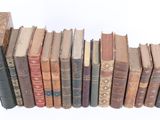 a lot of old books stacked on top of each other