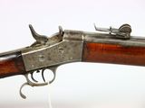 an old gun with a wooden handle on a white background