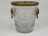a glass vase with a gold handle on a white background