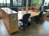 a desk with two chairs and a computer on it