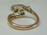 a gold ring with a diamond on it on a table
