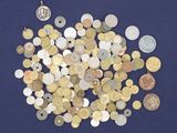 a lot of coins that are on a blue surface