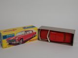 a red toy car in a box on a white surface