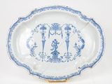 a blue and white plate with a picture of people on it