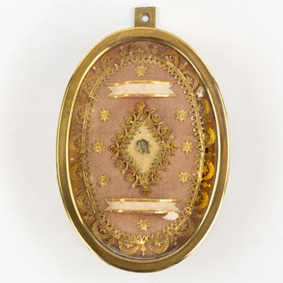 a picture of a gold locke with a picture of a woman on it