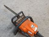 a chainsaw that is sitting on the ground