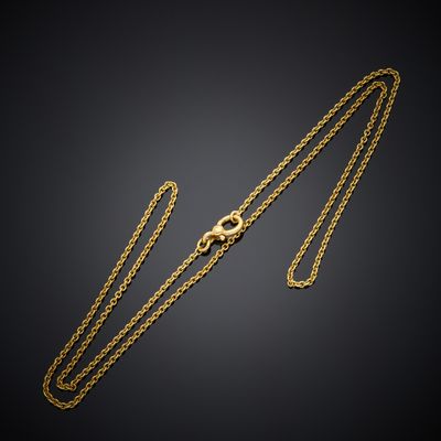 a gold chain with a clasp on a black background
