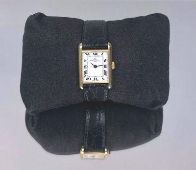 a black bag with a watch on it that is attached to it