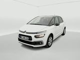 Une Citroën blanche est garée dans une pièce blanche