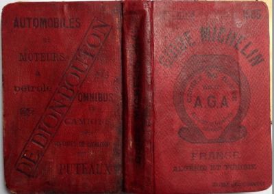 an old red book with a stamp on it sitting on top of a table