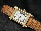 a close up of a wrist watch with roman numerals on it