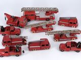 a lot of toy firetrucks sitting on a white surface