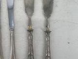 a group of silverware including knives, forks and spoons