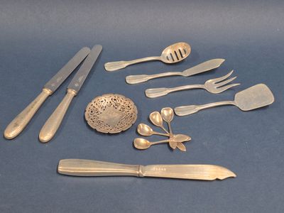 a lot of silverware on a blue surface