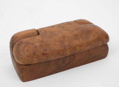 an old wooden box sitting on top of a white surface