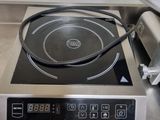 stainless steel counter top with a black burner on top of it