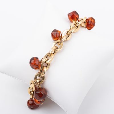 a close up of a bracelet on a napkin on a white surface