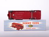 two red toy trains sitting on top of a box