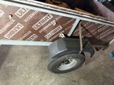 a dolly with a wheel attached to it in a garage