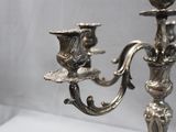 a silver candelab with two candles on it