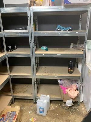 many shelves that are in the middle of a room