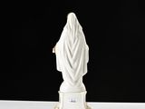 white statue of a woman with a veil on a white table