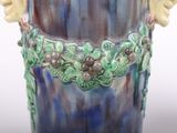 a blue vase with a gold decoration on it