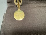 an image of a close up of a purse with a tag on it