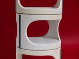a stack of three white shelves on a red background