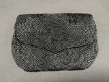 a black beaded purse sitting on top of a table