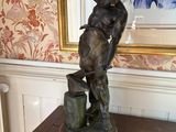 a statue of a man on a table in a room