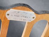 a sign on the back of a wooden chair