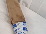 a cardboard bag wrapped around a piece of wood on a bed