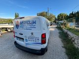 the van is parked on the side of the road in the parking lot