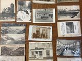 several old black and white photographs of people and buildings on a table