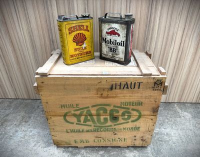 two cans of beer sitting on top of a wooden crate