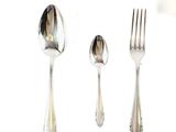 three spoons and a fork on a white surface