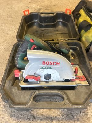 two tools in a tool box on the floor of a house