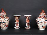 three vases are sitting on a black surface with a black background