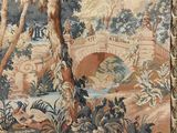 an image of a tapestry hanging on a wall with a bridge in the background